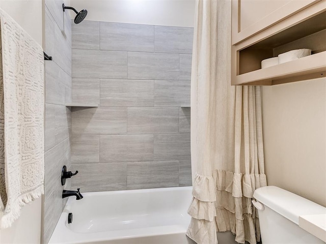 bathroom featuring shower / bathtub combination with curtain and toilet