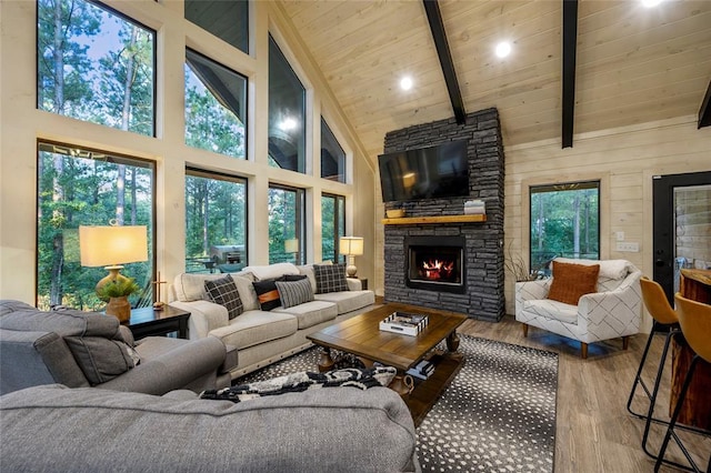 119 Secluded Cir, Broken Bow, OK 74728 - living area with wood finished floors, high vaulted ceiling, a wooden ceiling with exposed beams, and a stone fireplace