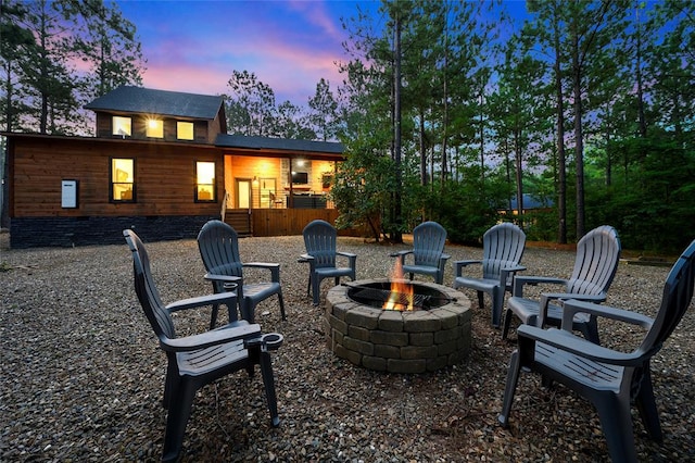 patio terrace at dusk featuring a fire pit