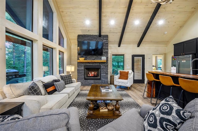 living room featuring beamed ceiling, hardwood / wood-style flooring, high vaulted ceiling, and wood ceiling