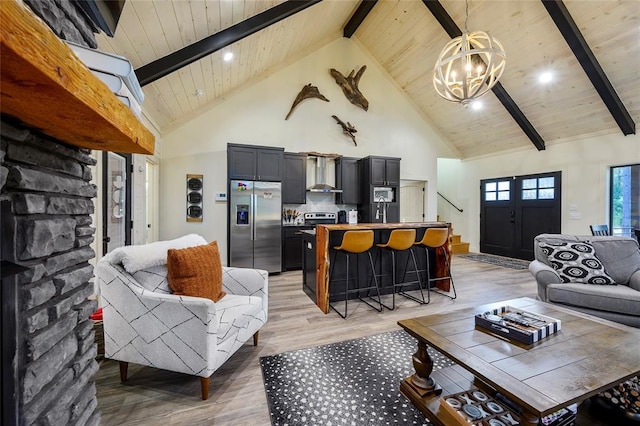 119 Secluded Cir, Broken Bow, OK 74728 - living area featuring high vaulted ceiling, light wood finished floors, a wooden ceiling with exposed beams, a chandelier, and stairs