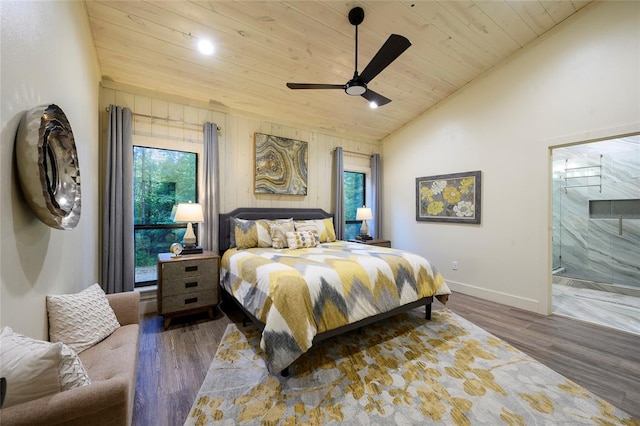 bedroom with ceiling fan, ensuite bath, dark wood-type flooring, and vaulted ceiling