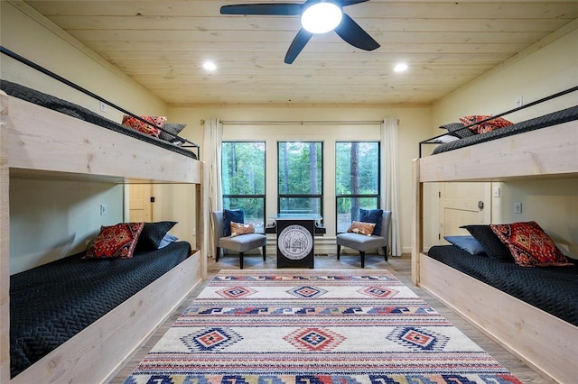 bedroom featuring hardwood / wood-style floors, ceiling fan, and wood ceiling