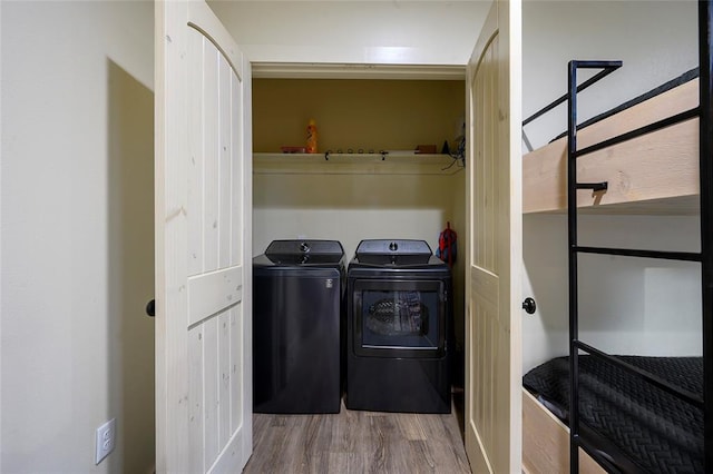 clothes washing area featuring independent washer and dryer and hardwood / wood-style flooring