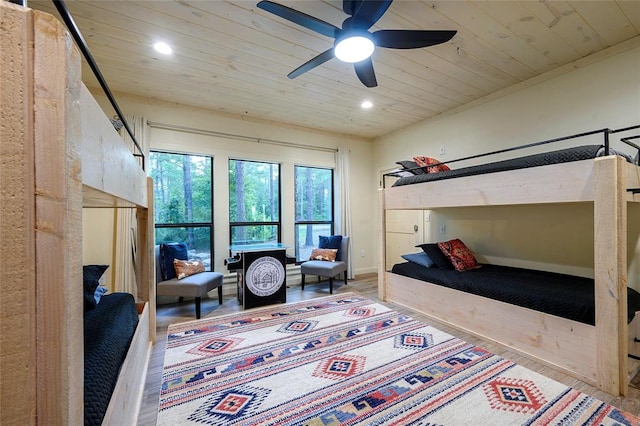 bedroom featuring hardwood / wood-style flooring, ceiling fan, and wood ceiling