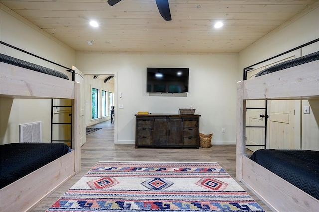 bedroom featuring ceiling fan, light hardwood / wood-style floors, and wooden ceiling