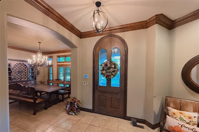 foyer featuring crown molding and a chandelier