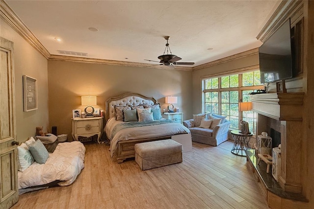 bedroom with crown molding, ceiling fan, and light hardwood / wood-style floors