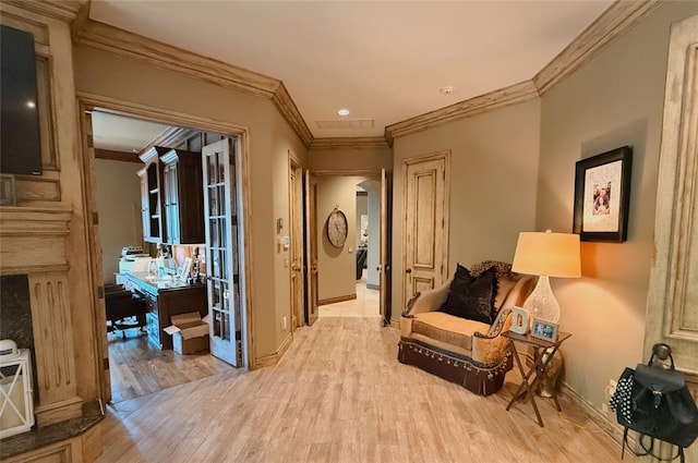 sitting room featuring crown molding and light wood-type flooring