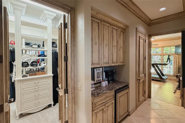 hall with decorative columns, light hardwood / wood-style flooring, and crown molding