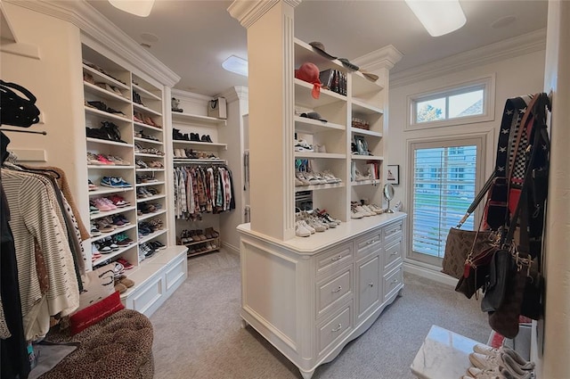 spacious closet featuring light carpet