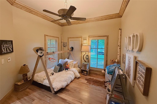 bedroom with hardwood / wood-style flooring, ceiling fan, and crown molding