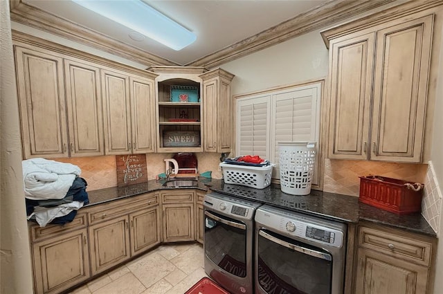 clothes washing area with sink, cabinets, independent washer and dryer, and crown molding