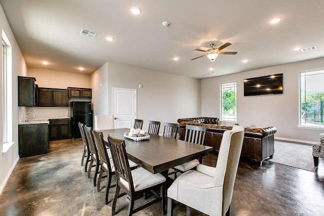 dining area featuring ceiling fan and sink