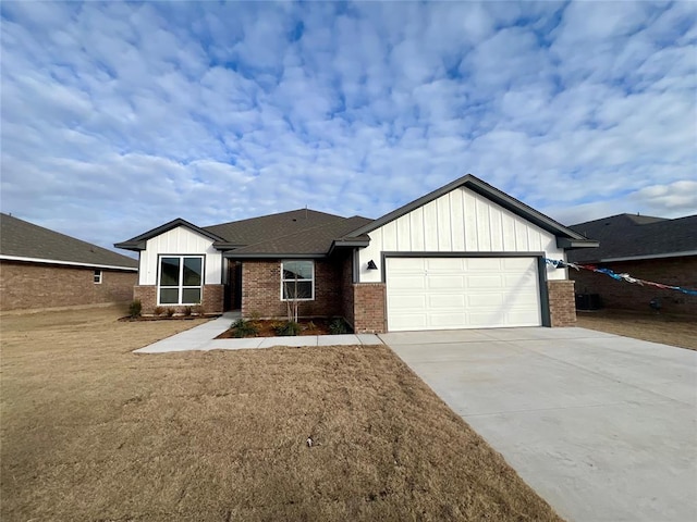 view of front of home with a garage and a front lawn