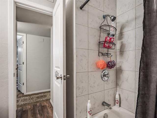 bathroom featuring hardwood / wood-style flooring and shower / tub combo with curtain