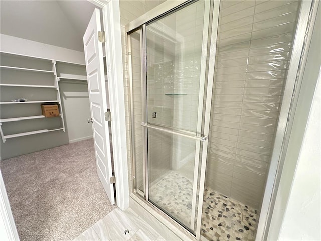 bathroom with lofted ceiling and walk in shower