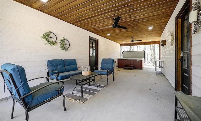 view of patio / terrace featuring ceiling fan, an outdoor hangout area, and a hot tub