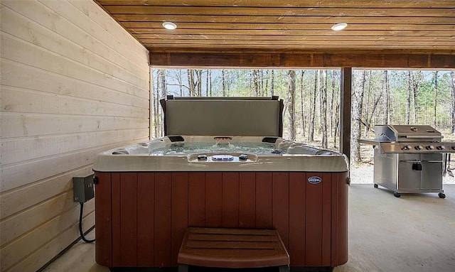 exterior space with area for grilling and a hot tub