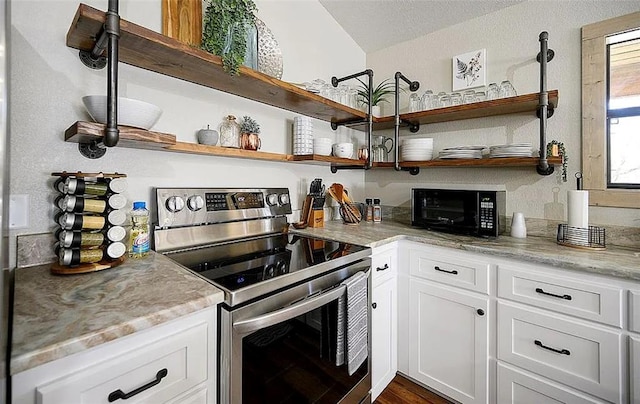 kitchen with white cabinets, light stone countertops, stainless steel electric range oven, a textured ceiling, and dark hardwood / wood-style flooring