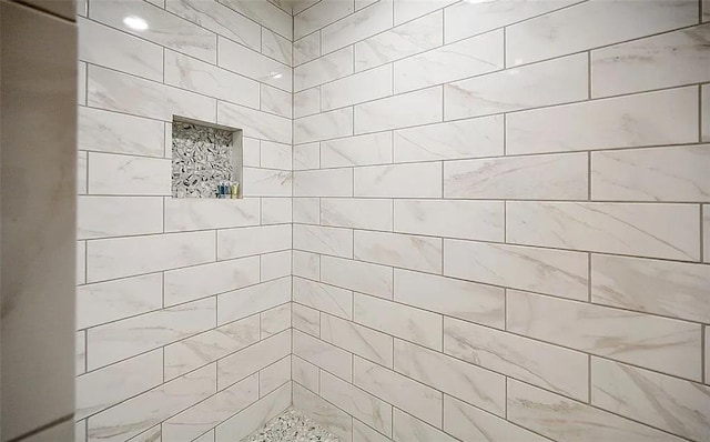 bathroom with a tile shower