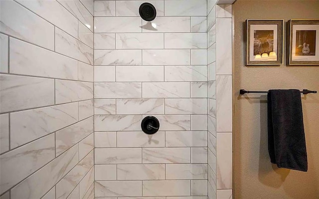 bathroom with a tile shower