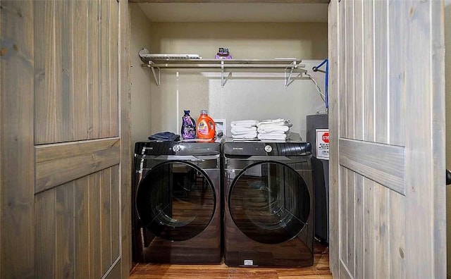 washroom with hardwood / wood-style flooring and independent washer and dryer