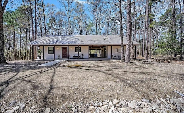 ranch-style home with a porch and a carport