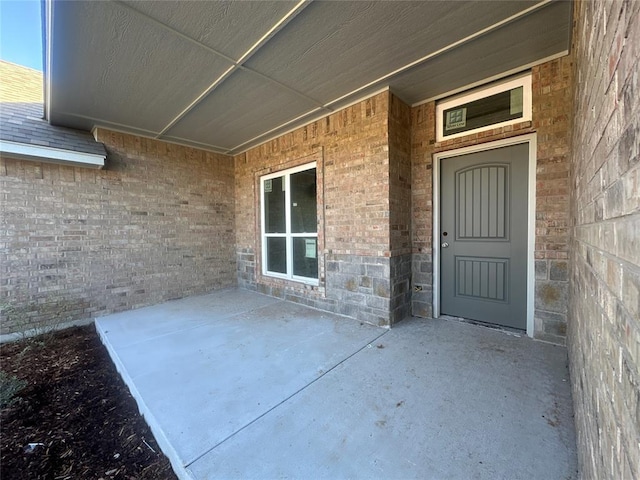 property entrance with a patio area