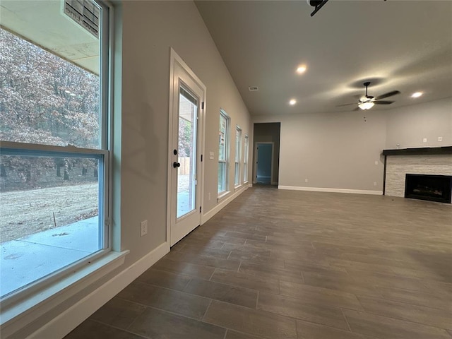 unfurnished living room with ceiling fan and dark hardwood / wood-style flooring