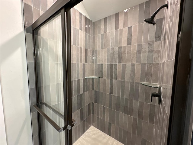 bathroom featuring an enclosed shower and lofted ceiling