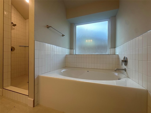 bathroom featuring tile patterned flooring, separate shower and tub, and vaulted ceiling