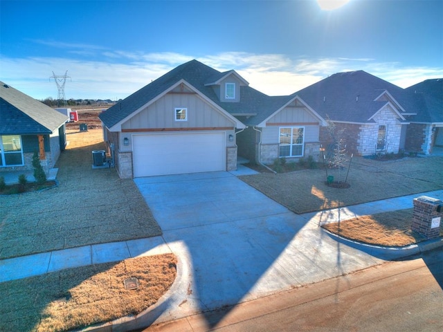 view of front of property featuring a garage and central AC