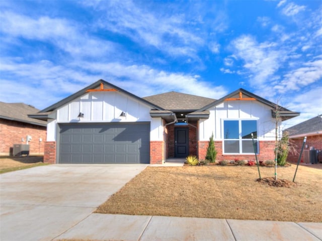 view of front of home with central AC and a garage