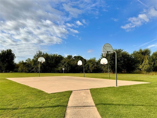 view of sport court featuring a lawn