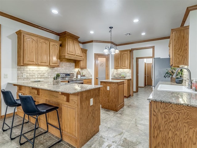 kitchen with light stone countertops, sink, a notable chandelier, kitchen peninsula, and appliances with stainless steel finishes