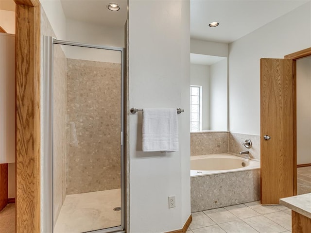 bathroom with tile patterned floors and separate shower and tub