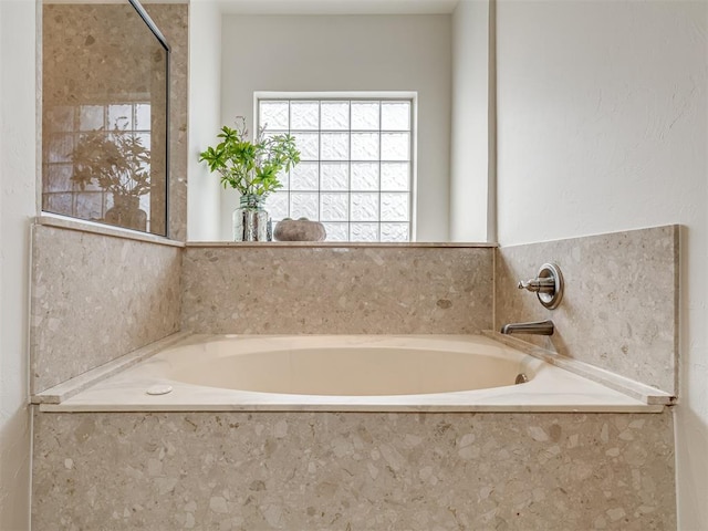 bathroom featuring tiled tub