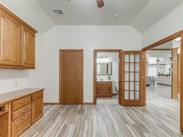 kitchen featuring french doors, light wood-type flooring, vaulted ceiling, and ceiling fan