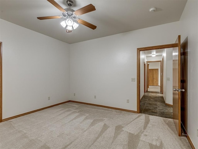 unfurnished room featuring dark colored carpet and ceiling fan