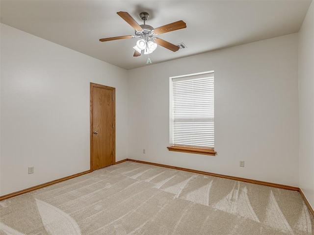 carpeted spare room featuring ceiling fan