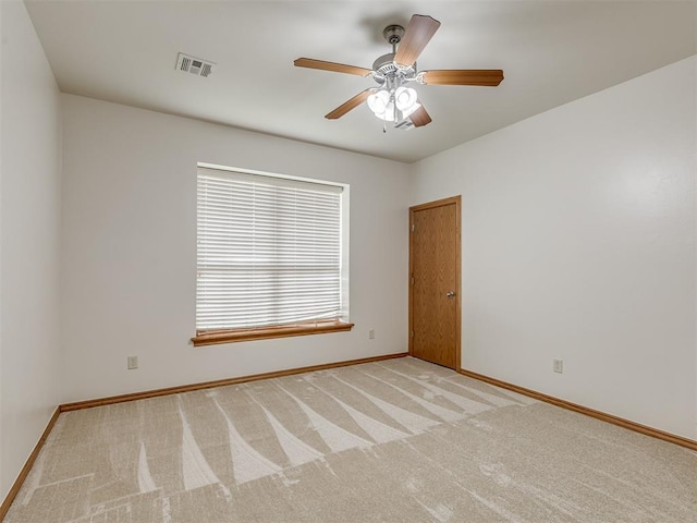 spare room featuring ceiling fan and light carpet