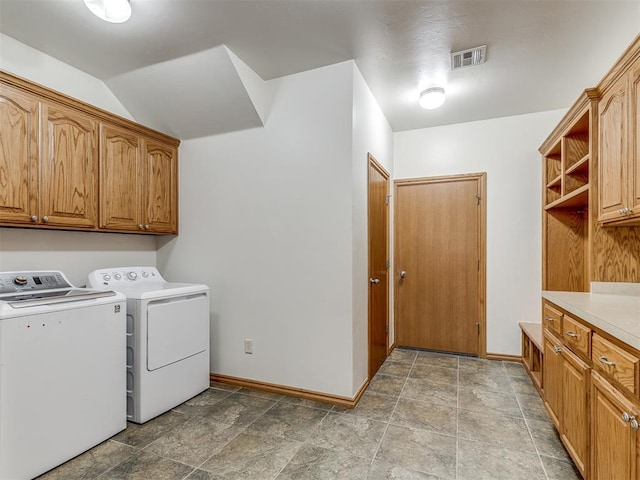 laundry room with washer and clothes dryer and cabinets