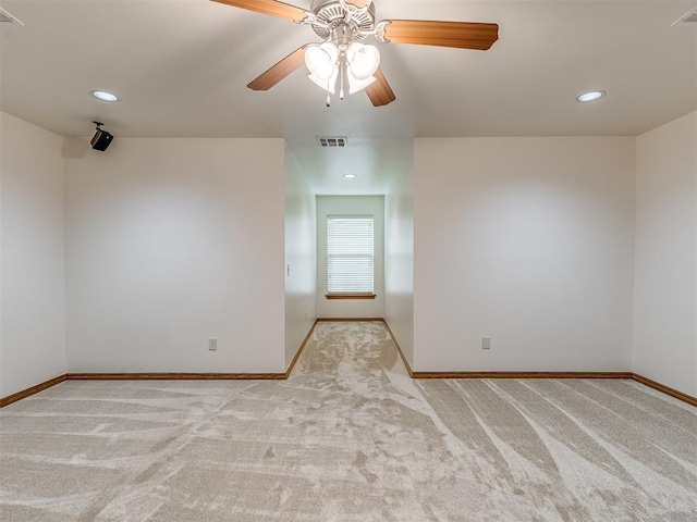 spare room featuring ceiling fan and light colored carpet