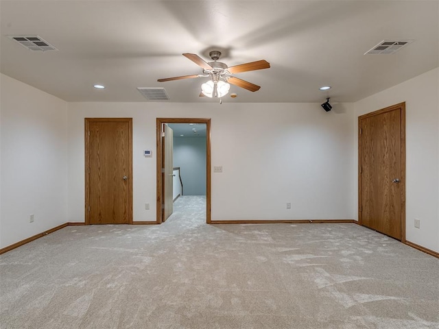 carpeted spare room featuring ceiling fan