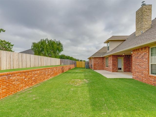 view of yard with cooling unit and a patio area