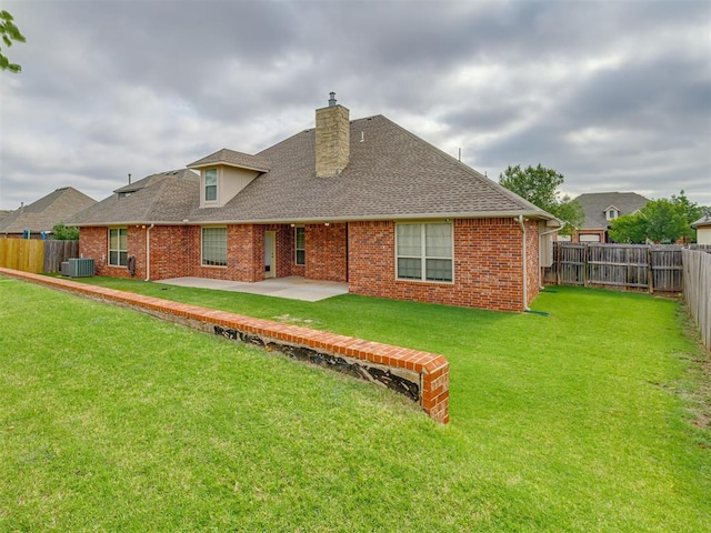 back of house with a patio, central AC, and a lawn