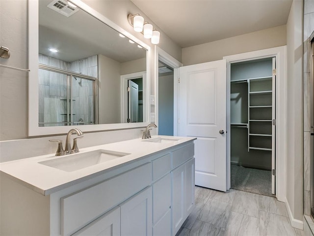 bathroom featuring vanity and a shower with shower door