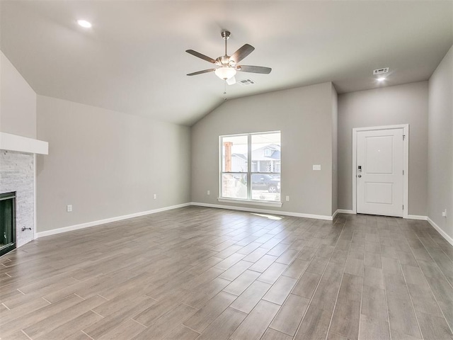 unfurnished living room featuring ceiling fan, a fireplace, and lofted ceiling