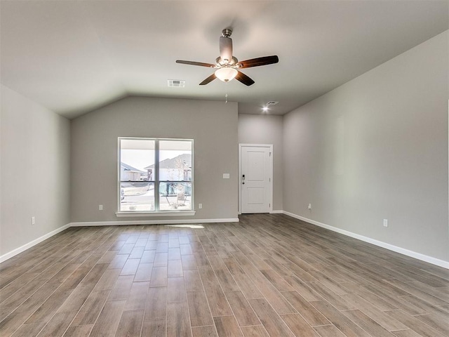 empty room featuring light hardwood / wood-style flooring, ceiling fan, and lofted ceiling